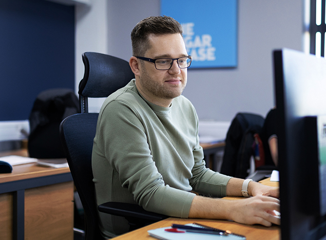 Bluestorm's Content Marketing Manager Matt Holden sat at his desk